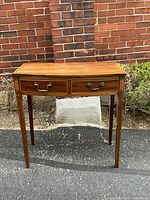 Front view of Georgian inlaid side table showing two drawers and brass pulls