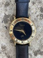 Front view of watch showing dial, bezel, strap wear