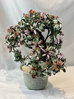 Front angled view showing jade leaves, glass flowers, ceramic pot