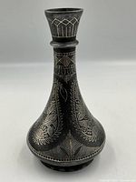 Front view of Bidriware vase showing inlaid floral motifs