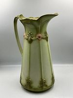 Front view of pale green Art Nouveau style ceramic pitcher