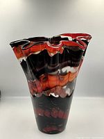 Front view of ruffled multicolour art glass vase