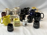 Group shot of all ceramic whisky advertising pitchers