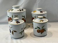 Group view of all four Royal Worcester Evesham canisters with lids