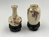 Front view of both Satsuma vases on stands