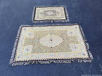 Two tapestries side by side showing relative sizes and full design