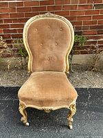 Front view of Victorian slipper chair showing frame, upholstery, cabriole legs and porcelain casters