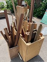 Two containers filled with assorted scrap wood