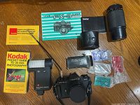 Overall view of camera body, Vivitar lens, Vivitar case, flash, filters, manuals, cleaning paper, shutter release cable