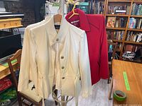 White jacket and red jacket on hangers