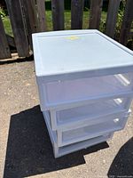 Stack of four plastic drawers, side view