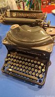 Full view of Underwood Noiseless typewriter showing keys and damaged top cover