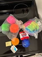 All packaged and loose dog toys on stovetop