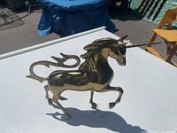 Left side view of brass unicorn figurine