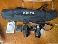 Overall kit: camera with lens, extra lens, charger, manual, Kinyo tripod bag