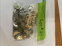 Sealed plastic bag labeled collection of foreign coins showing quantity