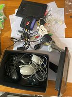 overview of lot showing digital photo frames, box of mice, cables