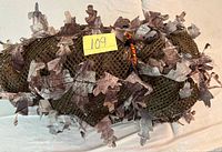 Suit rolled and secured showing mesh and leaf material