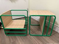 Two cube chairs showing reversible design, green metal frame, wood panels
