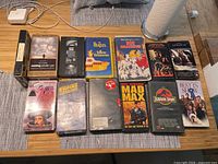 All 12 tape cases plus cassette and player remote on table