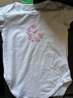 White onesie with pink unicorn graphic