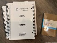 Front covers showing three of the Triform Investigations Record Books and sealed Moleskine pack