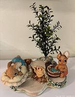 Front view of figurines on stand showing overall detail