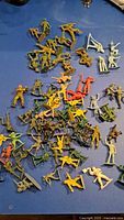 Top view of mixed color plastic figurines scattered on surface