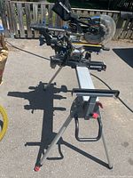 Full view of miter saw on folding stand outdoors