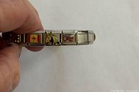 Side view of Italian charm bracelet showing Canadian flag, donkey, photo charm
