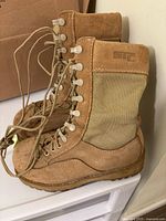Side view of pair of tan STC steel toe boots