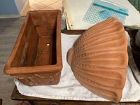 Rectangular planter beside shell wall planter