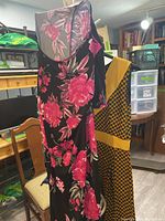 Both dresses hanging to show overall designs and colors