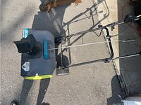 Top view of Yardworks snow blower showing full unit and folded handle