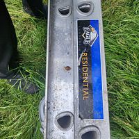 Close-up photo showing the Eagle Ladders logo and 'Residential' label on the aluminum ladder rail.
