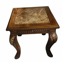 Single marble-top carved wood side table showing detailed ornate carvings on legs and apron with gold-tone accents, visible marble veining on top.