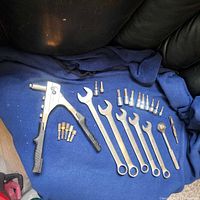 Work light tripod with twin halogen lamps, protective metal guards, and adjustable height frame in black steel.