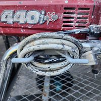 Sprayer housing showing “440iX” logo and coiled power cord on frame