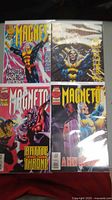 Photo showing all four Marvel Magneto comic books laid out together in protective sleeves.