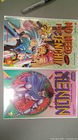Photo showing two comics: 'No Need for Tenchi!' and 'Xenon'. The 'No Need for Tenchi!' comic has anime-style characters on the cover. The 'Xenon' comic shows a warrior with cybernetic arm and purple clothing.