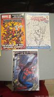 Three Marvel Spider-Man comic books displayed together on a flat surface.