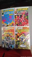 Four Marvel comic books featuring Silver Surfer and Warlock Resurrection series, displayed in protective sleeves on a red background.