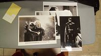 All four Batman movie pictures laid out on a table showing the variety and condition of the movie stills.