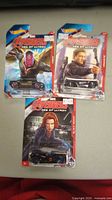 Three sealed Hot Wheels Avengers Age of Ultron diecast cars featuring Vision, Hawkeye, and Black Widow characters all on original backing cards.