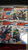 Four GI Joe Order of Battle comic books 1-4 arranged in two rows, showing full covers and colorful character artwork with military and patriotic themes.