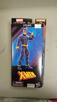 Front view of the sealed Cyclops figure in original Marvel Legends packaging with X-Men branding and price sticker.