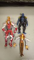 Lot of three Marvel Legends figures from above, showing all figures laid flat