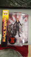 Photo of sealed Marvel Select Black Widow action figure in box, showing front of packaging with logo and figure inside.