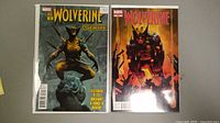 Two Wolverine comic books displayed side by side, showing covers and overall condition.