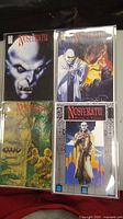 Four comic books Nosferatu 1-4 in plastic sleeves laying flat, showing covers, featuring vampire characters.